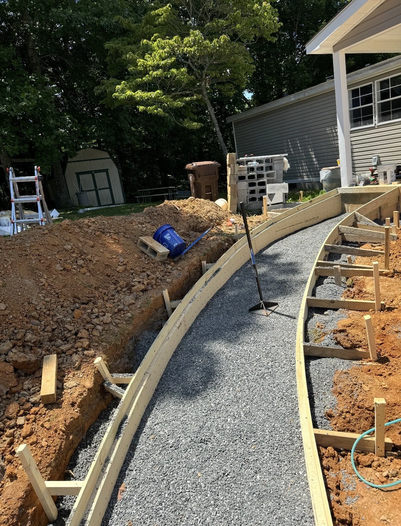 Construction site with a winding gravel pathway being built by Antonio's Construction serving Ashe and Watauga County in North Carolina.