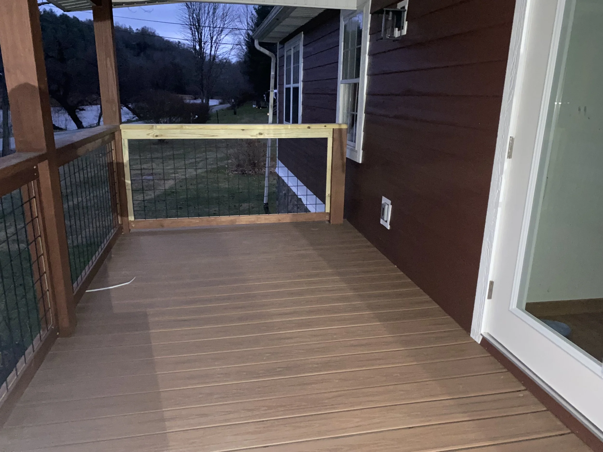A wooden balcony with a railing, built by Antonio’s Construction providing exterior construction in Ashe County and Watauga County, NC