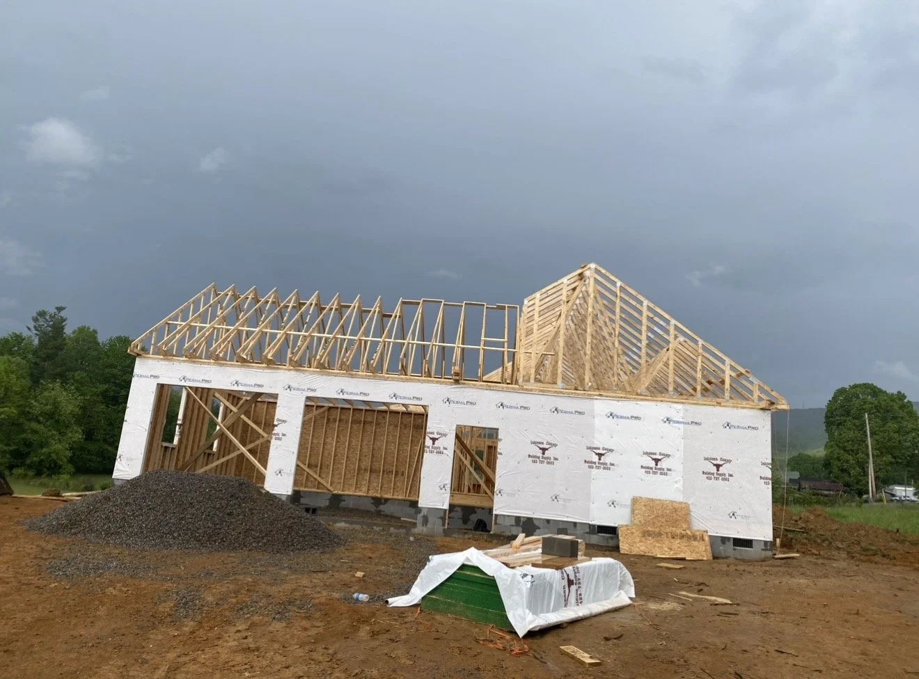 Construction site with a partially built house frame by Antonio's Construction serving Ashe and Watauga County in North Carolina.