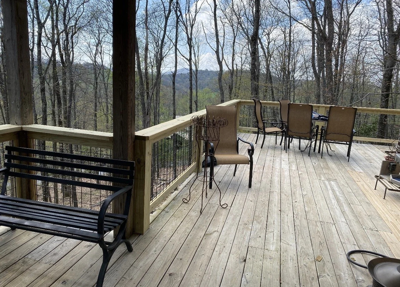 Wooden deck overlooking a forest built by Antonio's Construction serving Ashe and Watauga County in North Carolina.