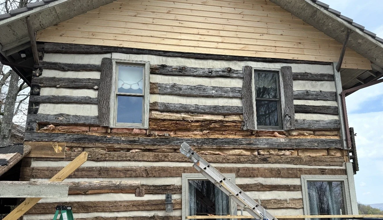 A house under renovation with exposed wooden logs and new framing by Antonio's Construction serving Ashe and Watauga County in North Carolina.