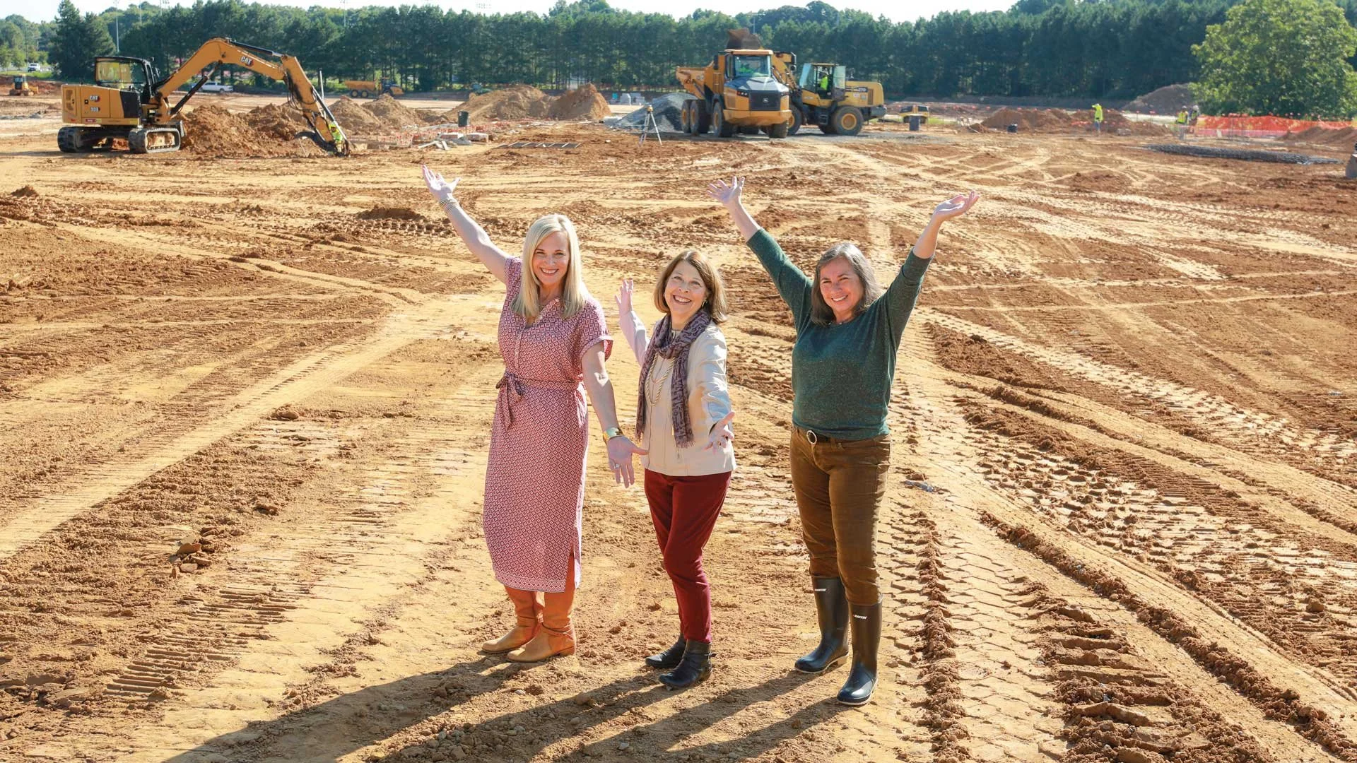 Lancaster County Superintendent Jessica Davis, RFA President Jamie Tucker, and RFA Office Administrator Donna McGrath are jumping for joy about the new Lancaster High School auditorium. Photo used courtesy of The Local Scoop magazine.