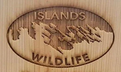 Wooden plaque with the words 'Islands Wildlife' and a carved map of the Caribbean islands.