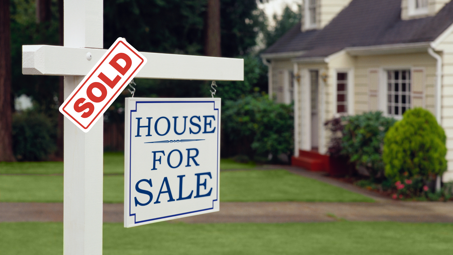 A "Sold" sign in front of a house – Real Estate businesses in the Les Cheneaux Islands