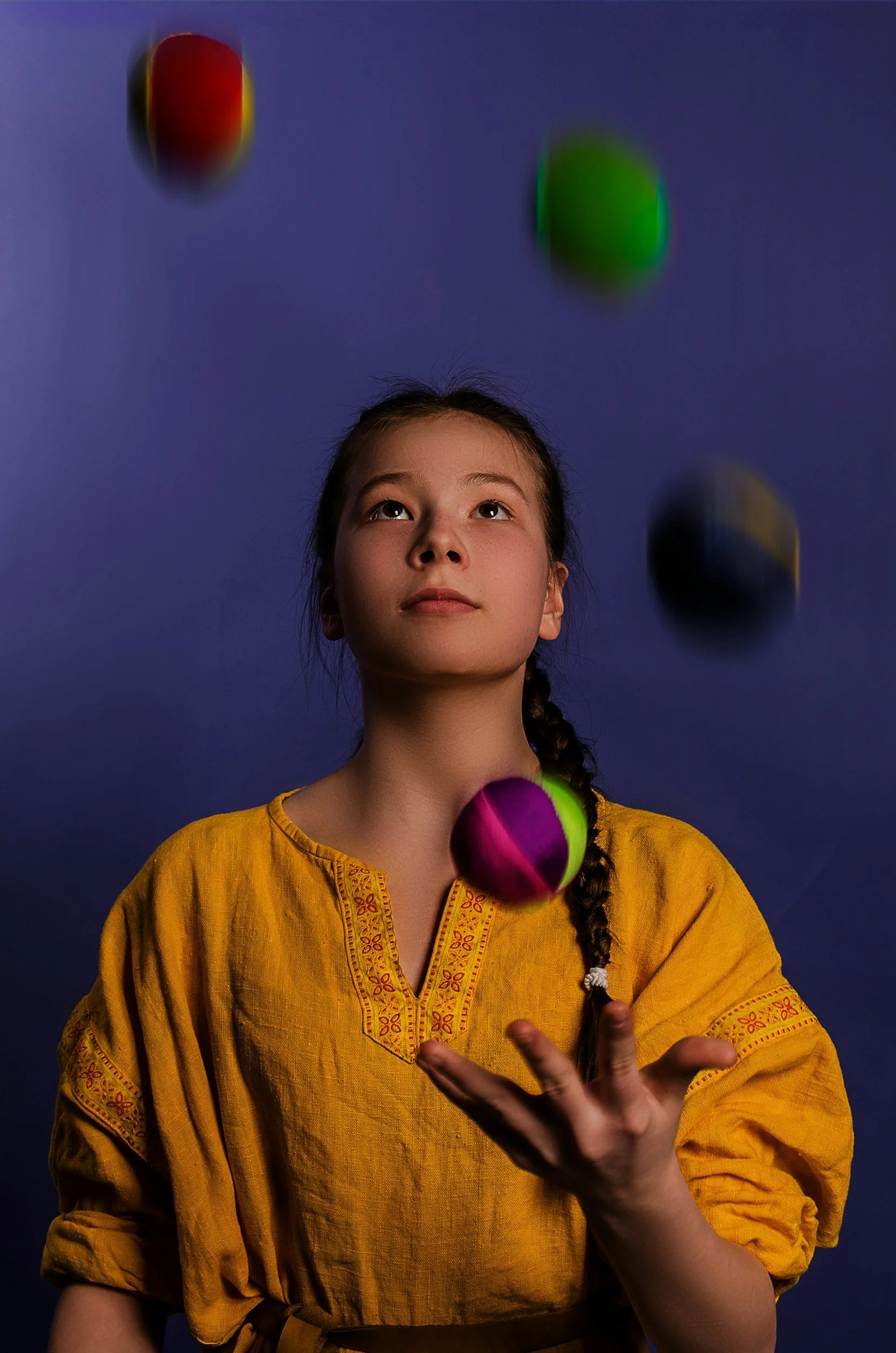 woman focused seriously looking up and juggling four things at once and trying not to drop anything