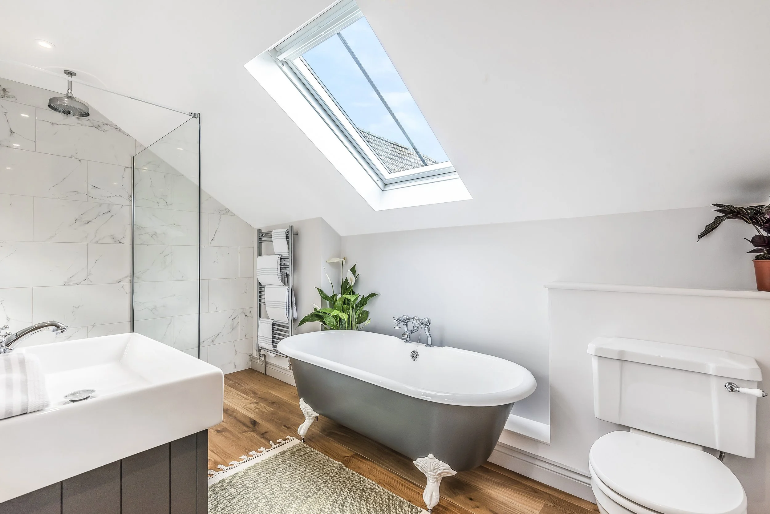 Bathroom with walk in shower and roll top bath