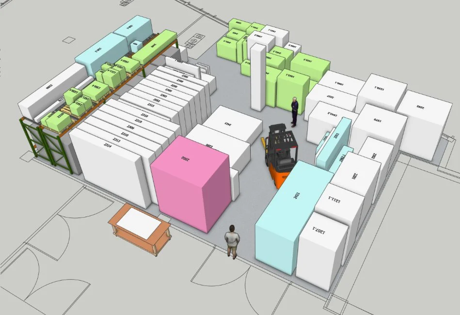 A warehouse storage layout with various colored boxes and pallets, including a forklift, two people, and a table, organized in an open area.