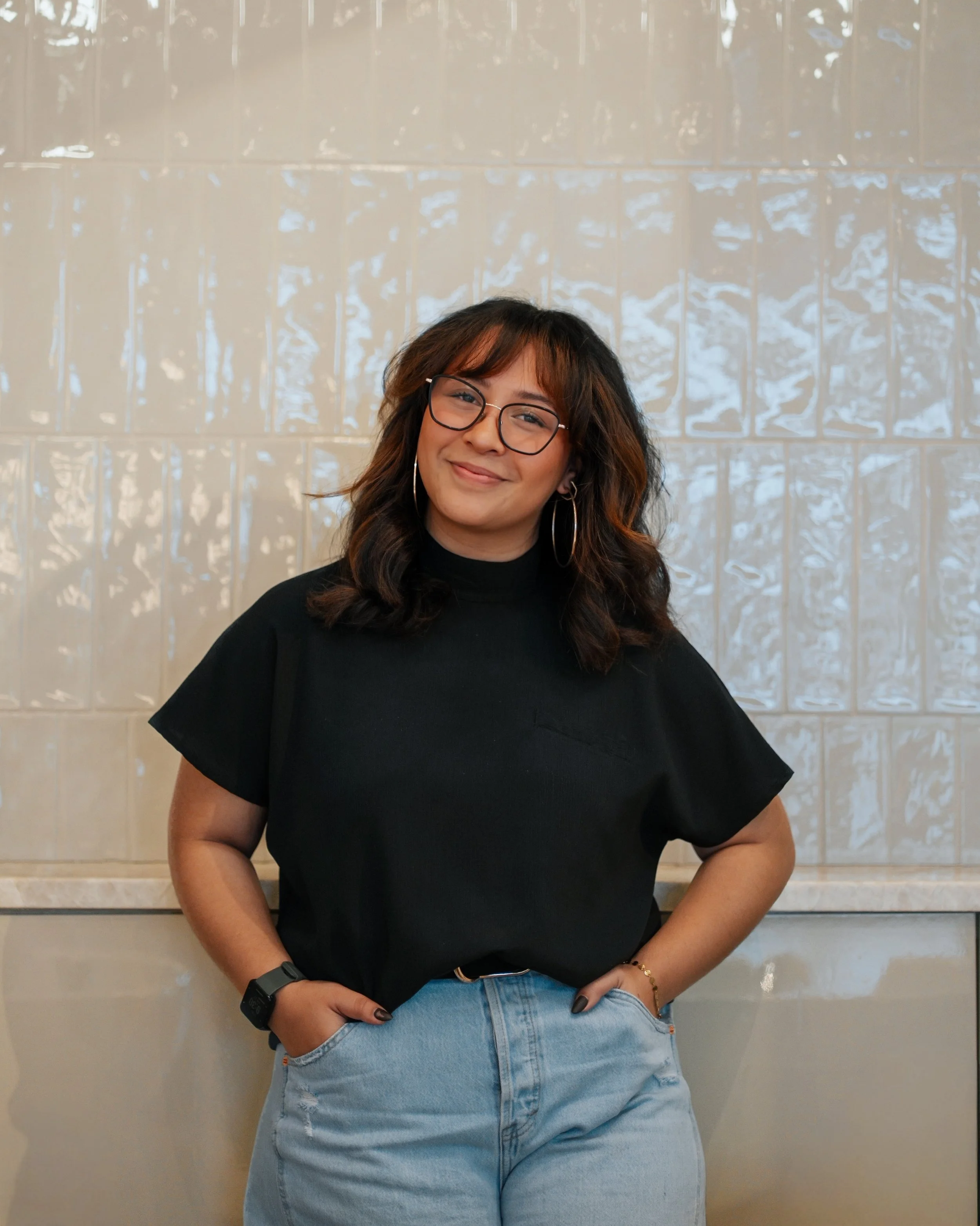 Latina hairstylist with brunette balayage and glasses