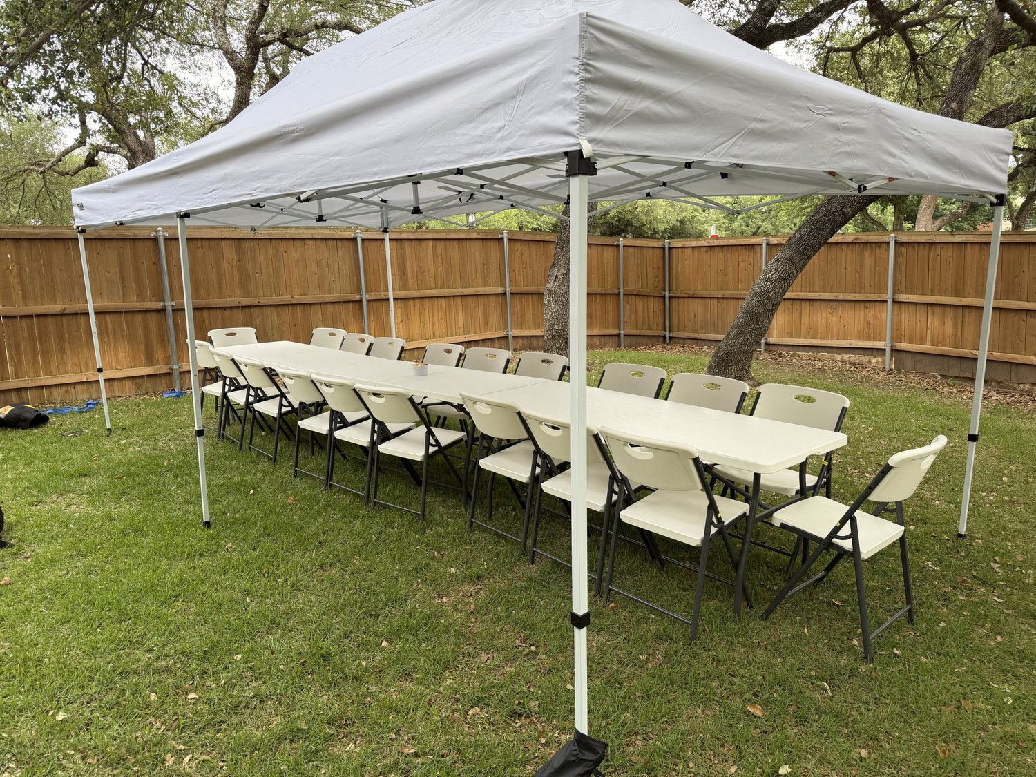 10×20 tent with tables and chairs at an HCCR event setup.