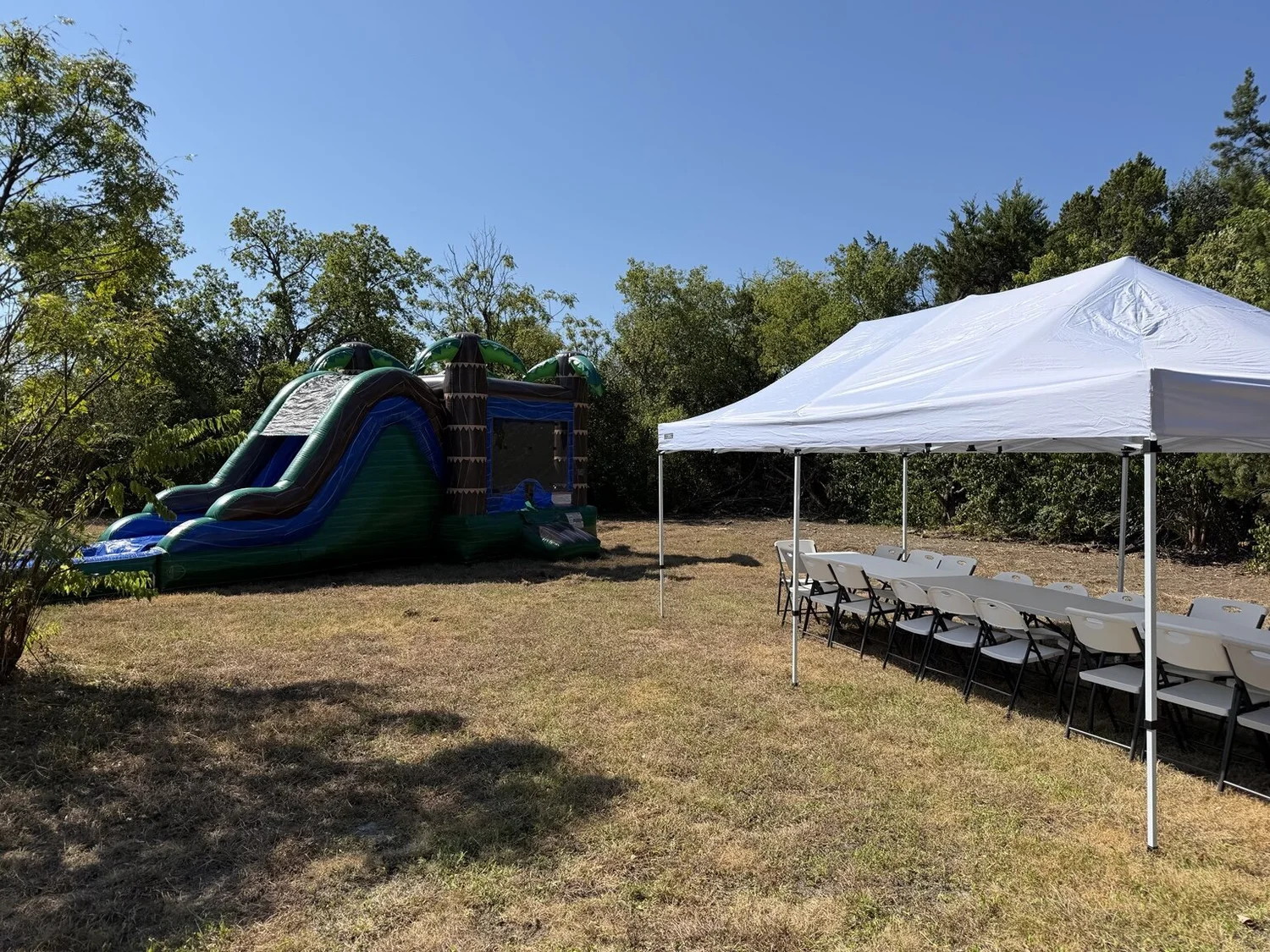 Palm Paradise Combo with an HCCR 10×20 tent, tables and chairs at a real party setup.