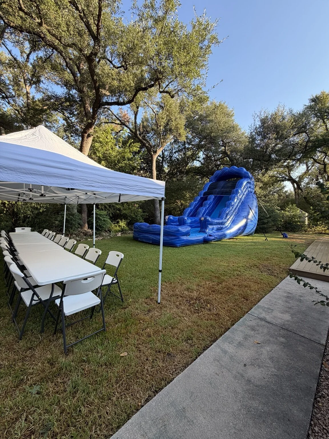 Tidal Wave Water Slide with HCCR tent, tables and chairs at a real party setup.