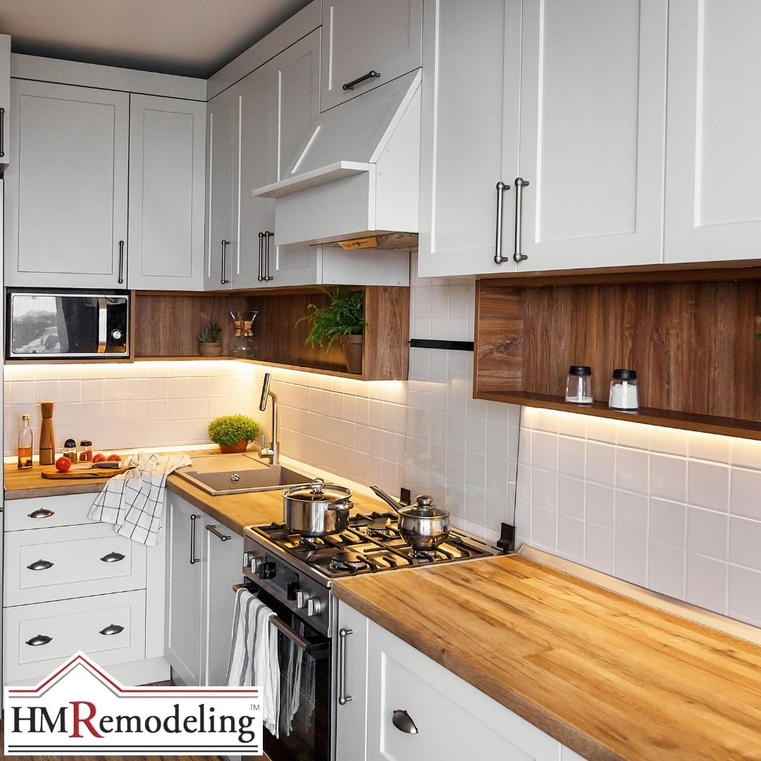 White shaker kitchen remodel with butcher block wood countertops, under-cabinet LED strip lighting, white subway tile backsplash, wood open shelving accents, and stainless appliances in a South Bend, Indiana home