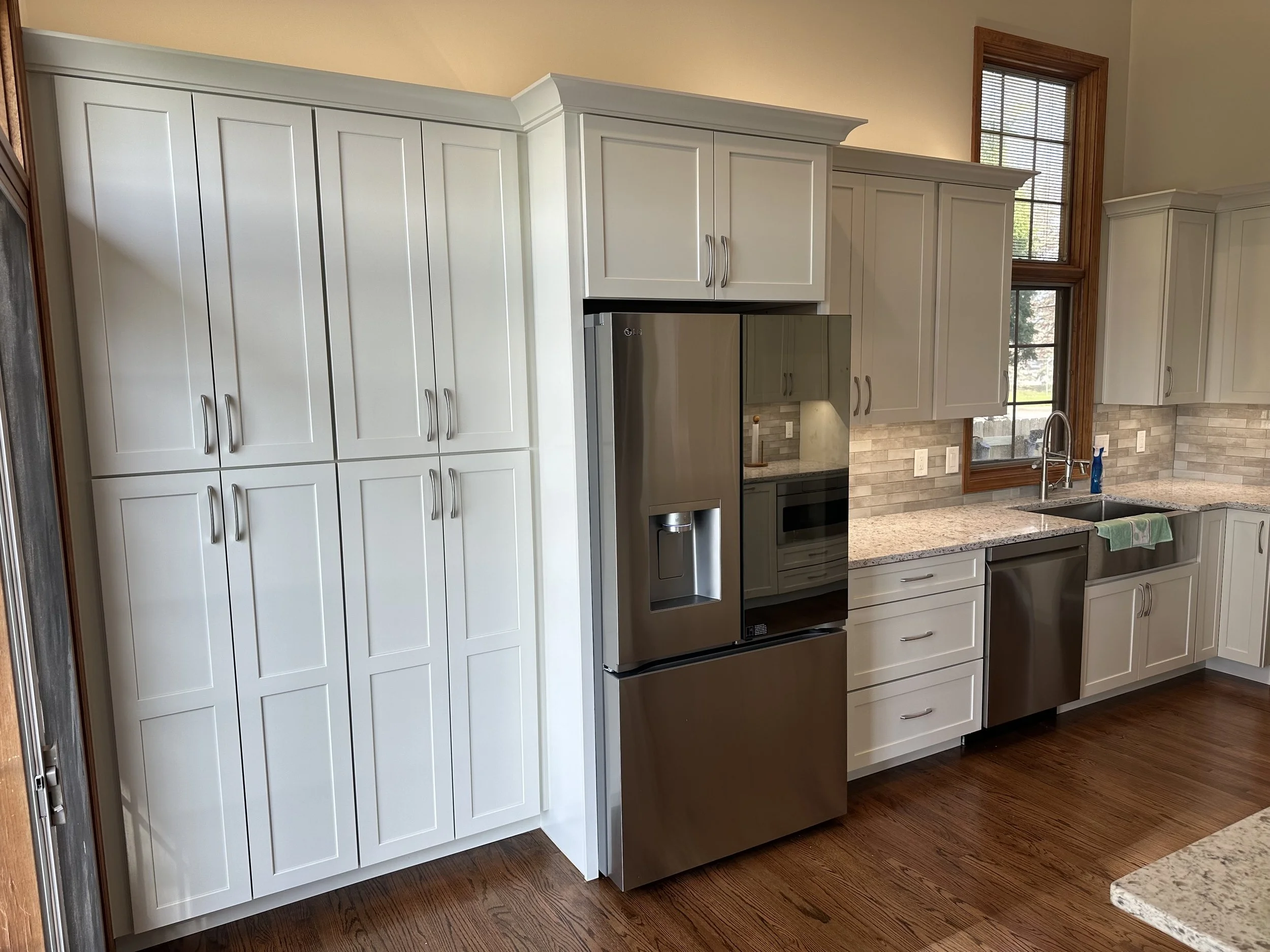 HM Remodeling white kitchen remodel featuring stainless steel smart refrigerator with screen in South Bend Indiana