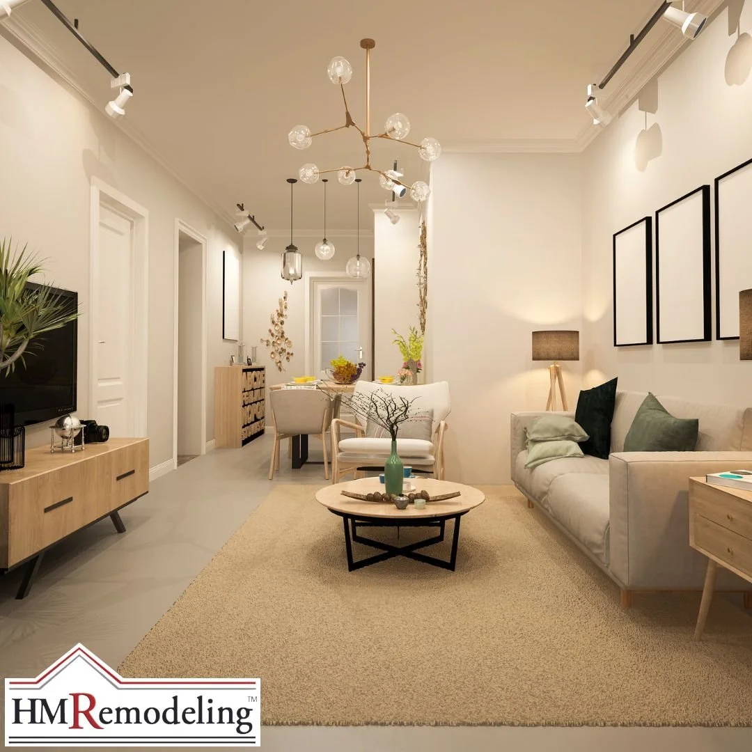 Open concept living and dining room with modern branching glass pendant chandelier, track lighting, crown molding, gray sofa with green accent pillows, and warm wood furniture in a South Bend, Indiana interior refresh