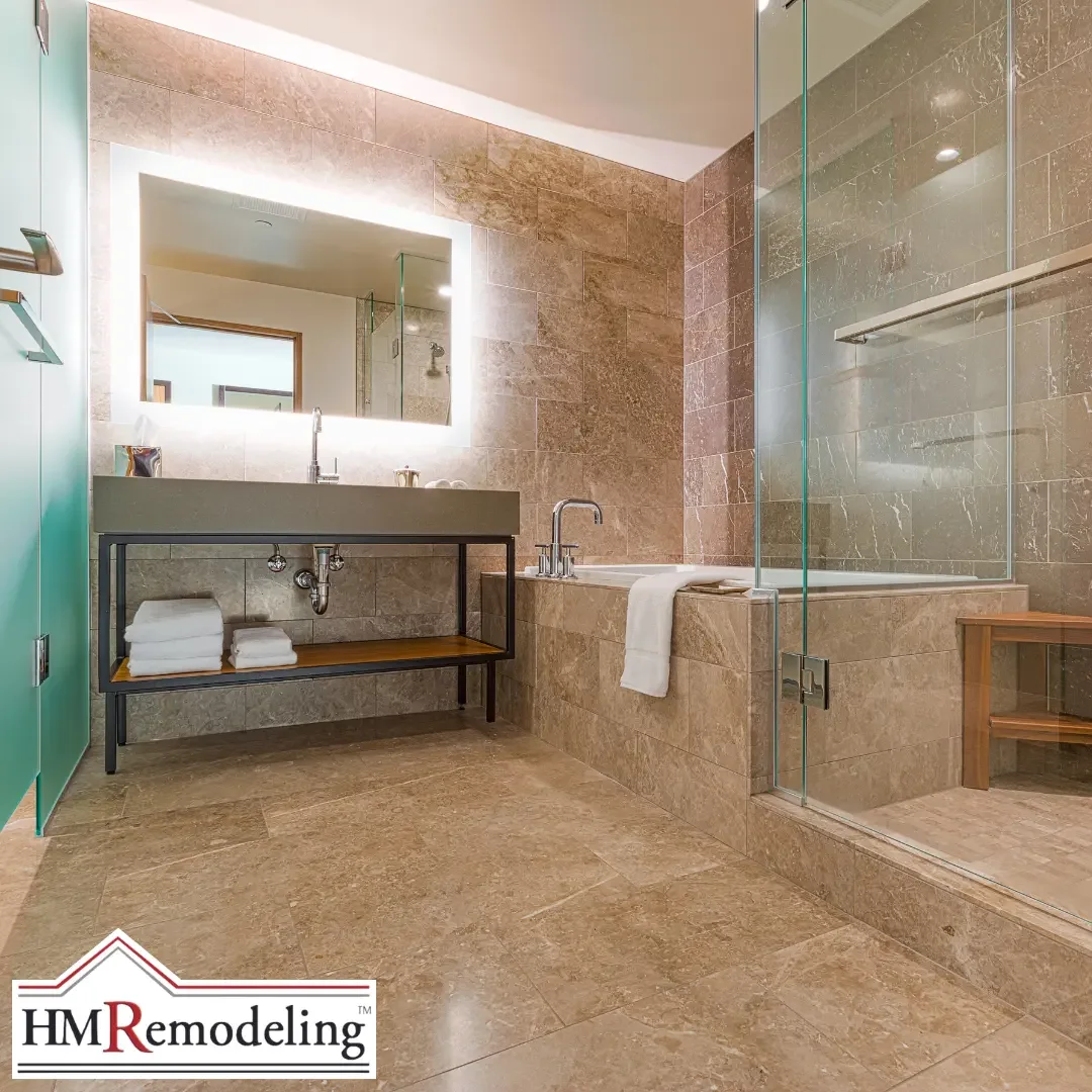 A spa-style bathroom with large beige tile, a backlit mirror, a walk-in glass shower, and a built-in soaking tub in a South Bend, Indiana home.