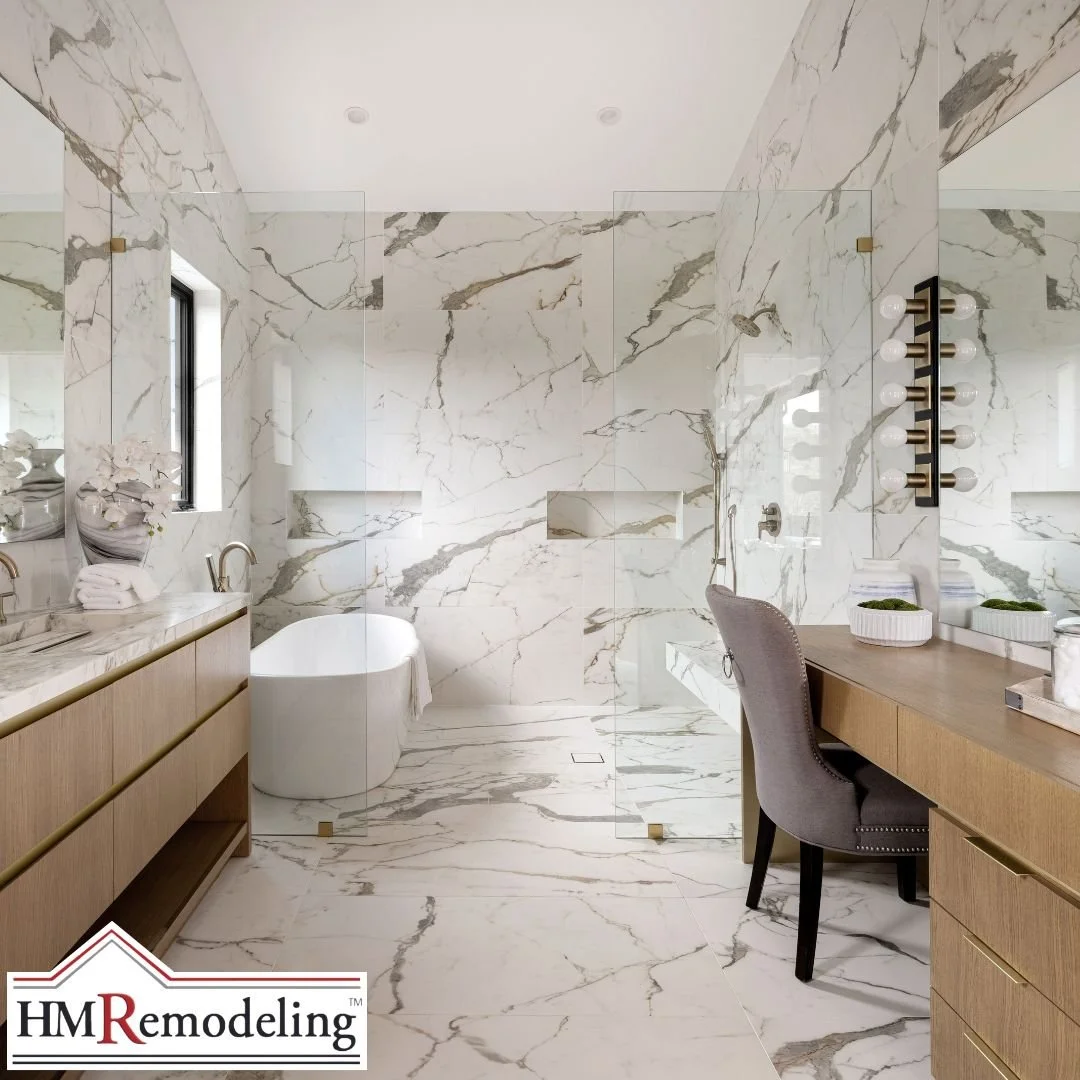 Luxury primary bathroom remodel featuring floor-to-ceiling marble tile, frameless walk-in shower, freestanding soaking tub, and double wood vanity in South Bend, Indiana