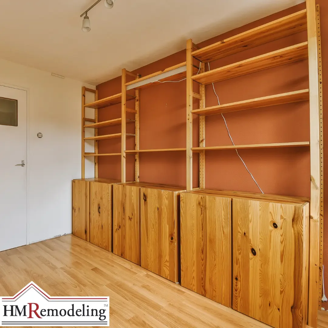 dated builder-grade pine shelving and cabinet unit with adjustable shelves and knotty wood cabinet doors mounted against a terracotta-painted wall in a South Bend, Indiana home, representing a pre-renovation baseline