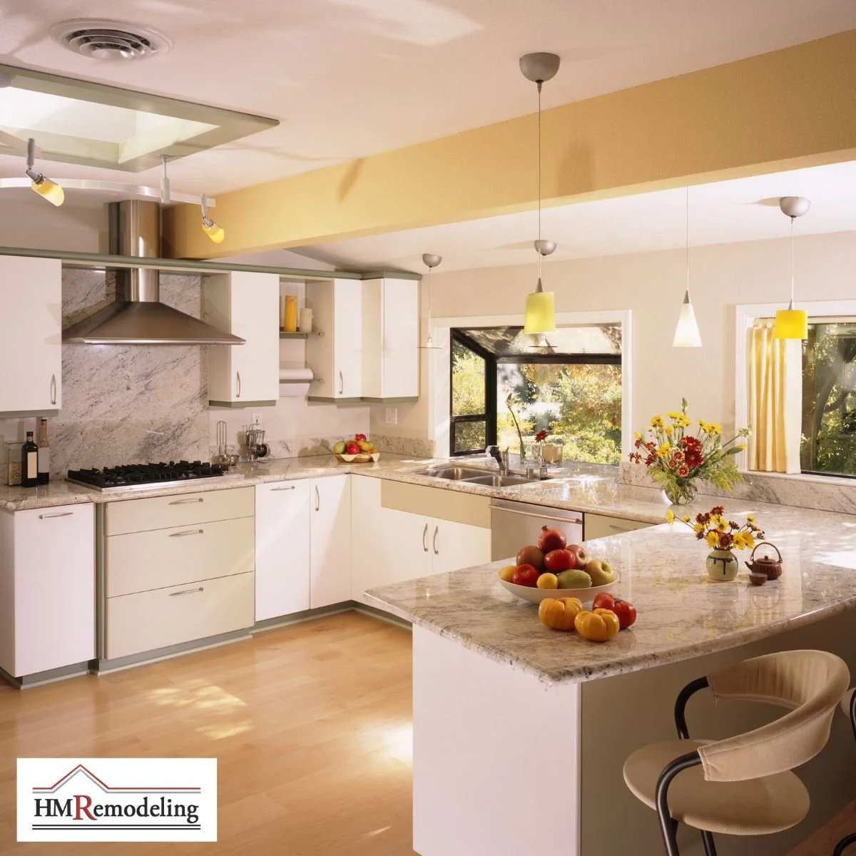 Open-concept kitchen remodel with white cabinetry, granite countertops, stainless steel range hood, kitchen island with bar seating, pendant lighting, and garden-view windows by HM Remodeling in South Bend, Indiana