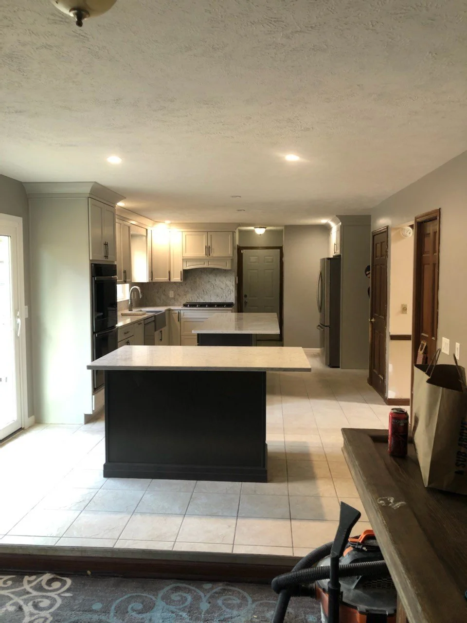 HM Remodeling dark modern kitchen remodel with island and dramatic lighting in South Bend Indiana