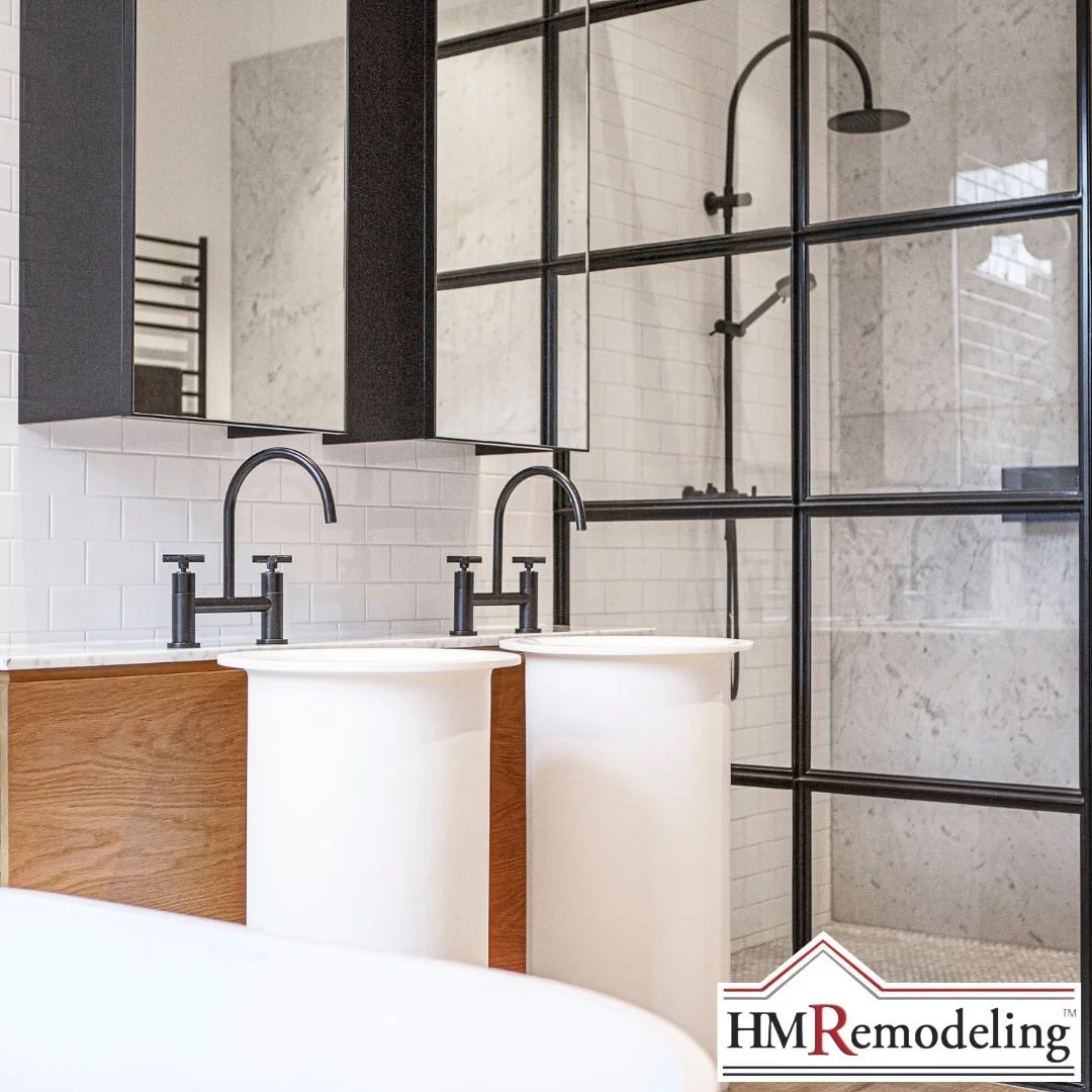 Double vanity with vessel sinks, matte black bridge faucets, wood cabinetry, and steel-frame glass walk-in shower enclosure in a South Bend, Indiana bathroom renovation