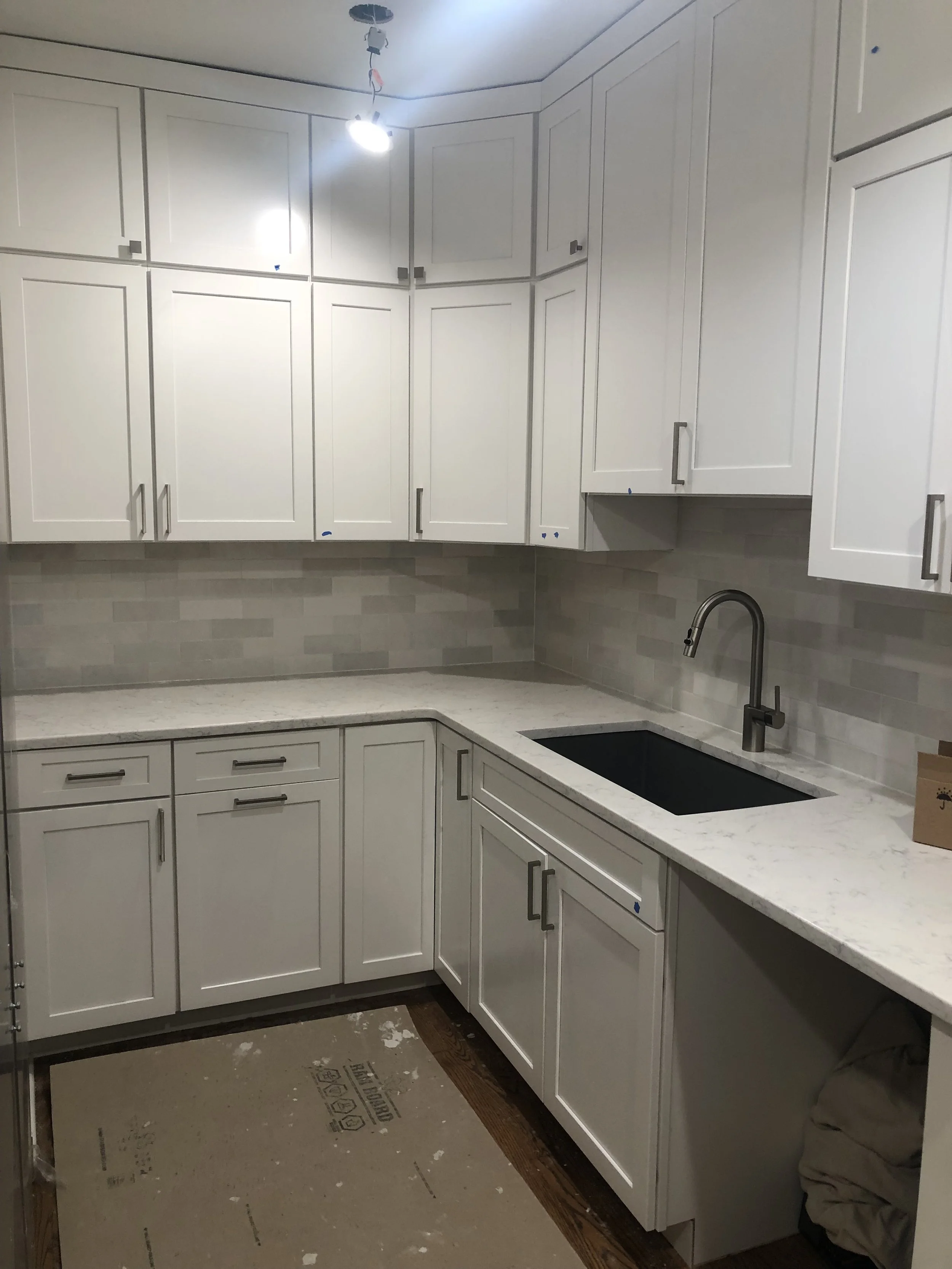 HM Remodeling white minimalist kitchen renovation with recessed lighting in South Bend Indiana