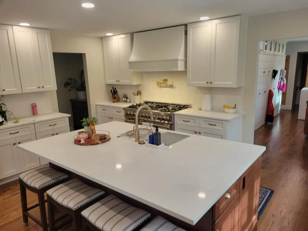 HM Remodeling white kitchen renovation with waterfall island countertop and stainless appliances in South Bend Indiana