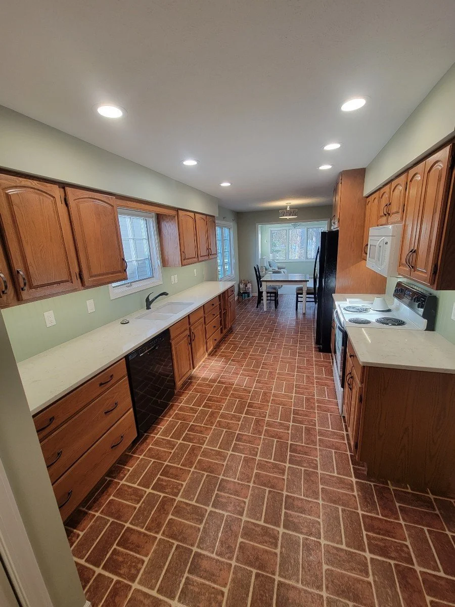 HM Remodeling open kitchen renovation with natural light and dark cabinetry in South Bend Indiana