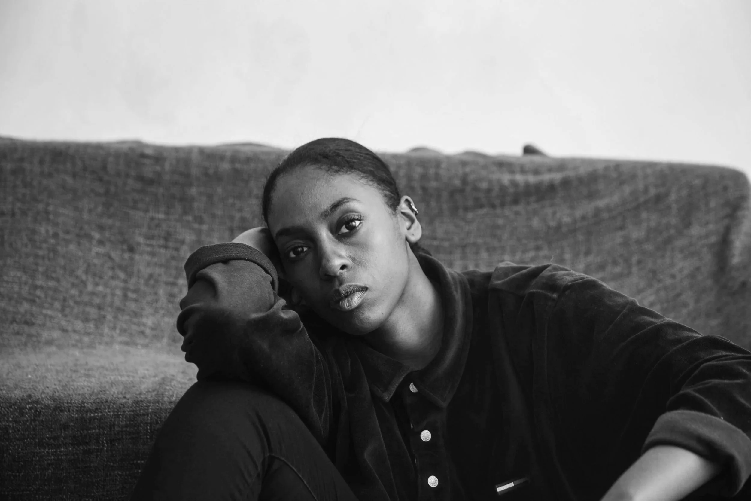 Black women looking directly at the camera, looking dejected.
