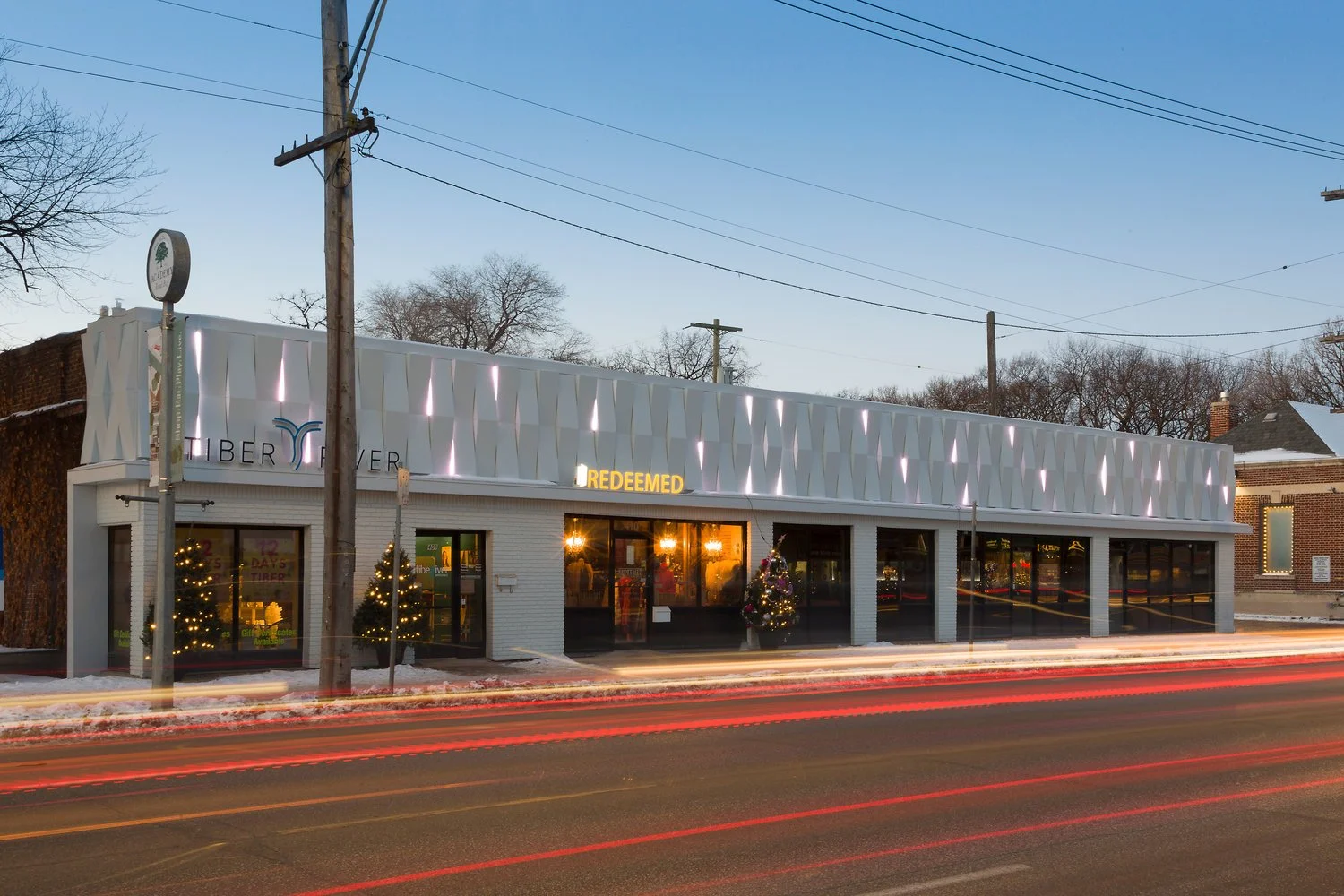 Modern commercial restaurant building with geometric white façade and large storefront windows.