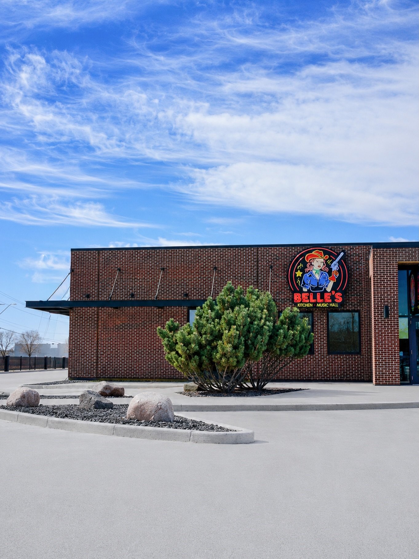 For Belle&rsquo;s Kitchen + Music Hall, our goal was to transform an existing commercial building into a destination with a strong architectural identity. Through strategic asset repositioning, the exterior was reimagined with a refined material pale