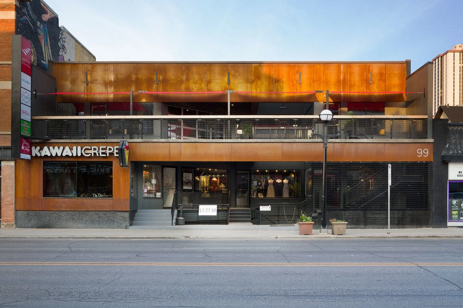 Copper coloured modern building on Osborne Street in Winnipeg with outdoor patio
