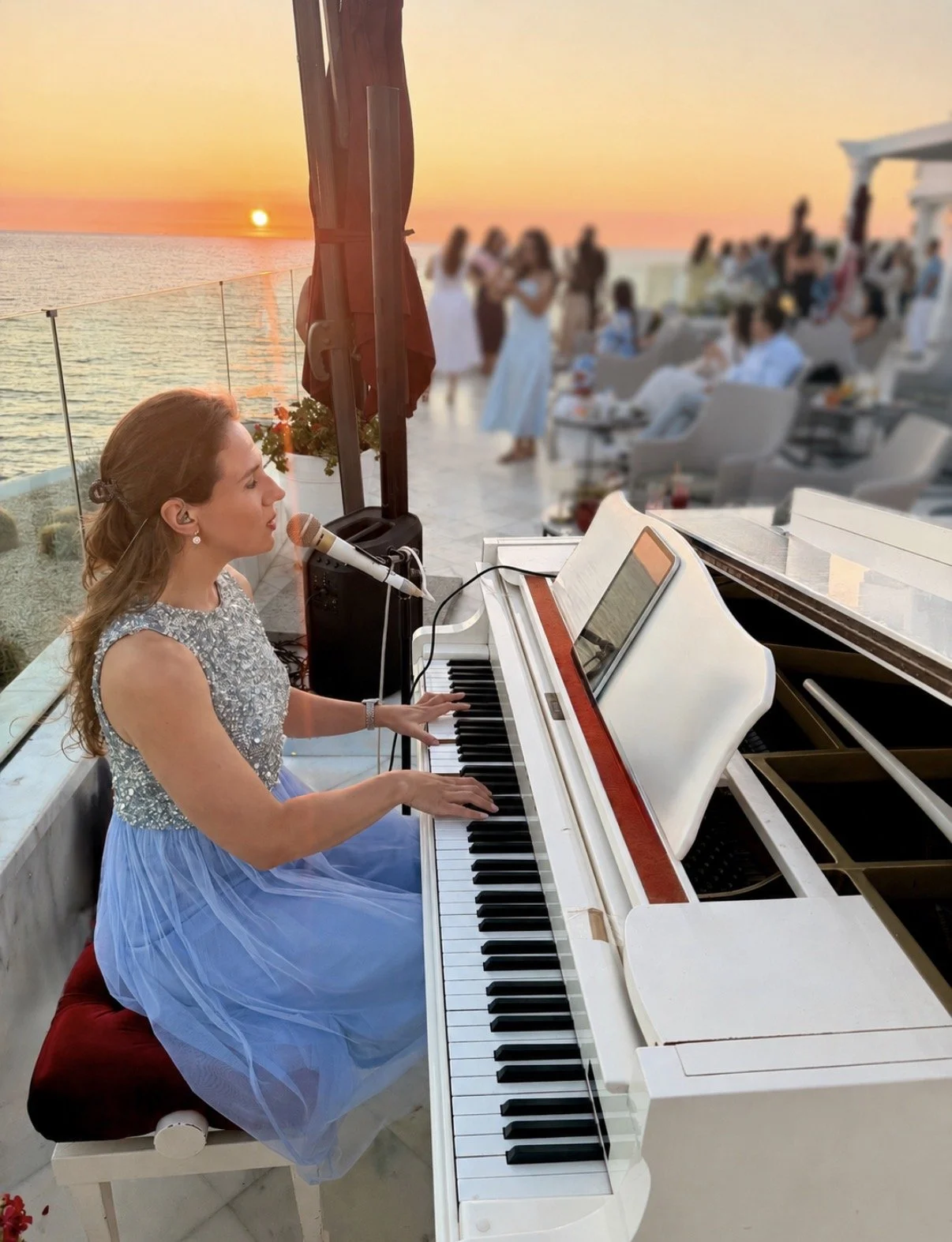 Kim Brooklyn performing live piano and vocals at sunset at Le Mirage in Tangier, Morocco