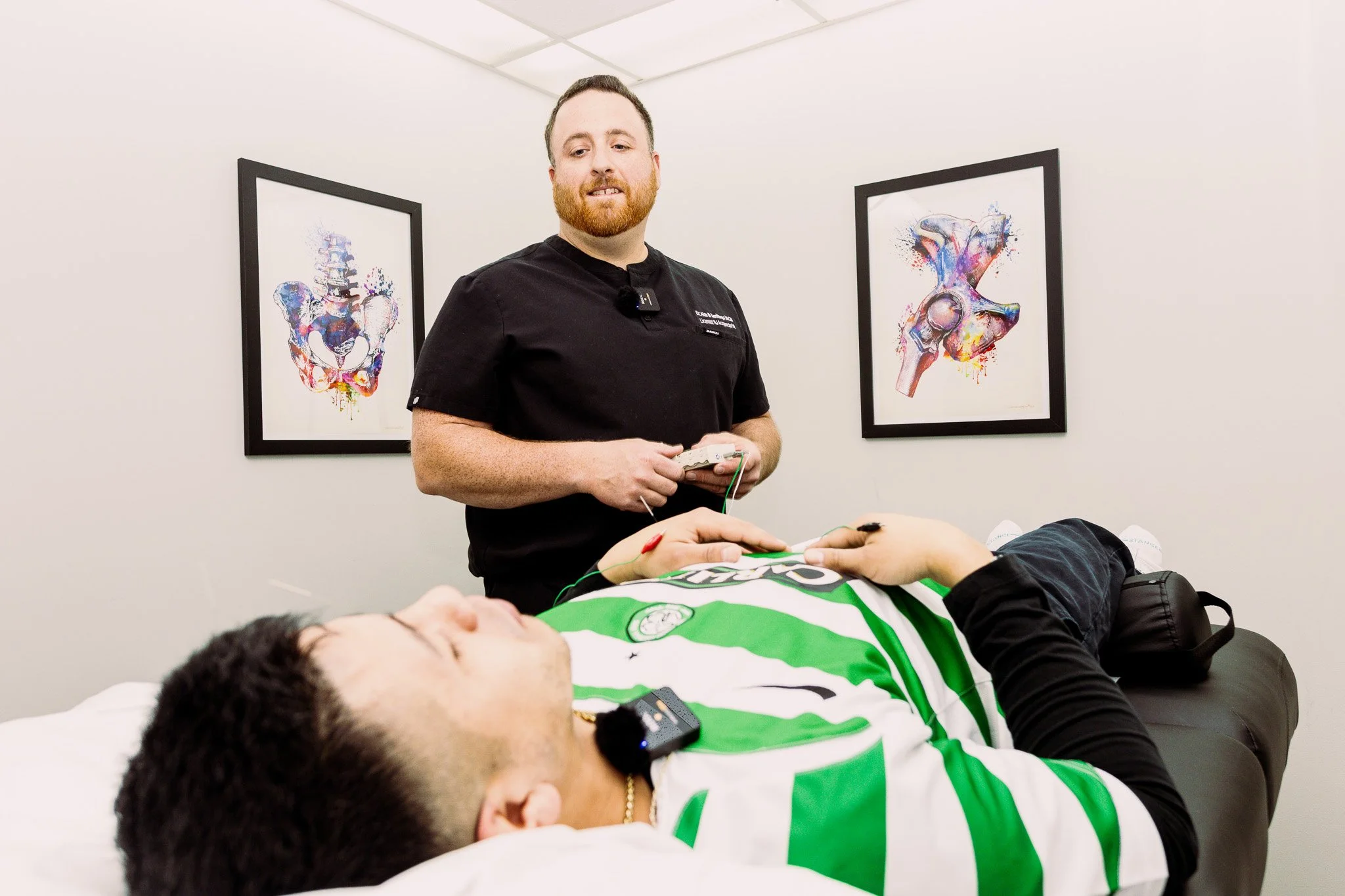 Medical professional performing a sleep study on a patient lying on a bed at a clinic.