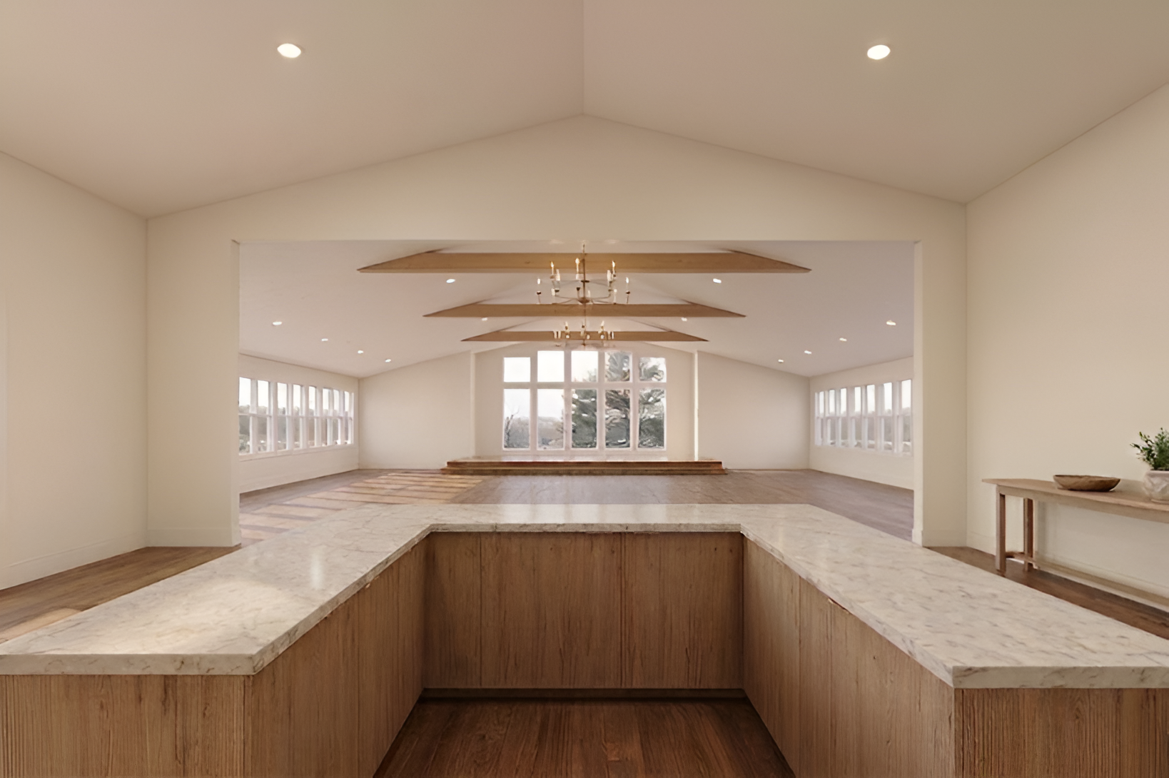 Bright dining area with long tables and white chairs, decorated with flowers, in a well-lit room with artwork on the walls