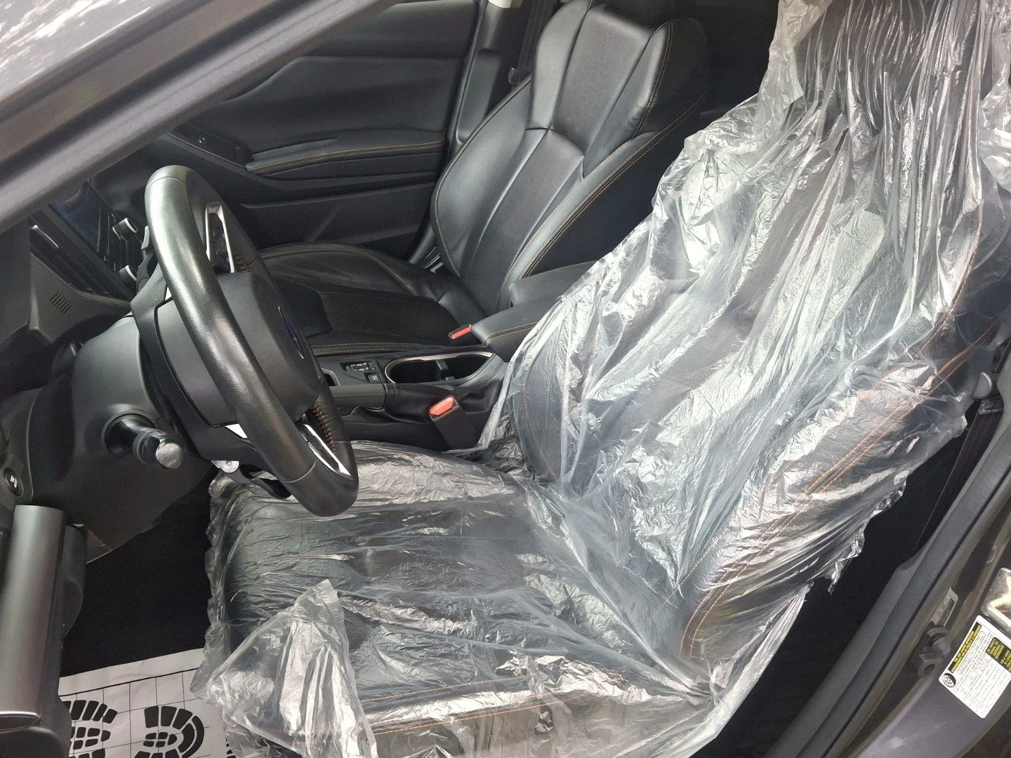Seat and floor protection installed before mobile European car maintenance service in Missouri City, Texas