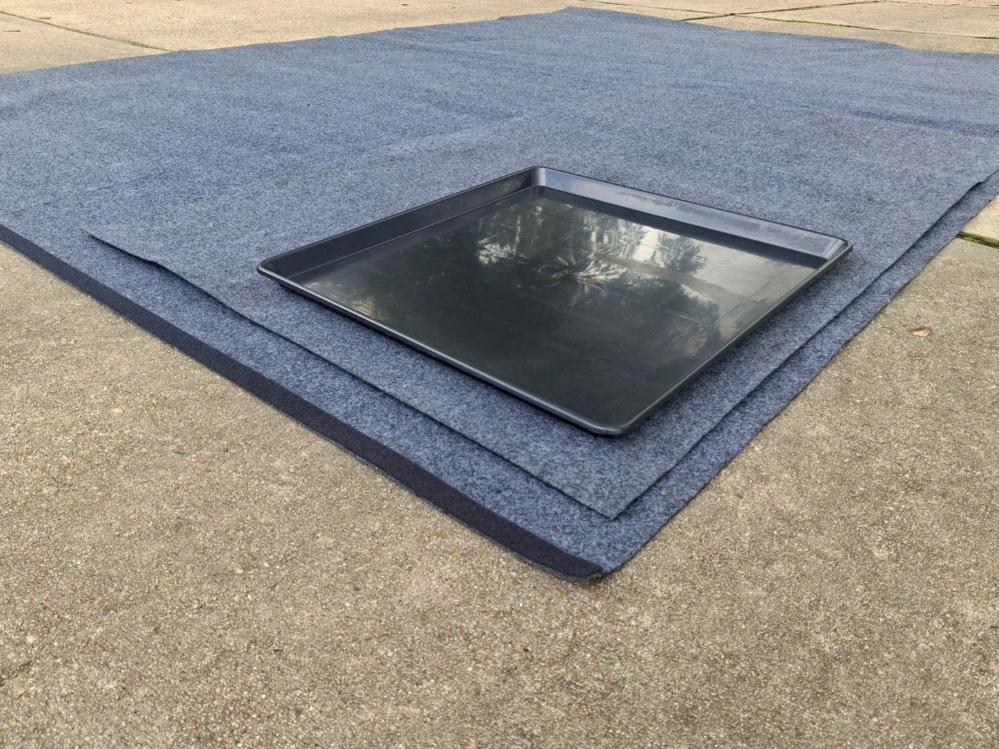 Three-layer driveway protection mat setup for mobile European car maintenance service in Missouri City, Texas
