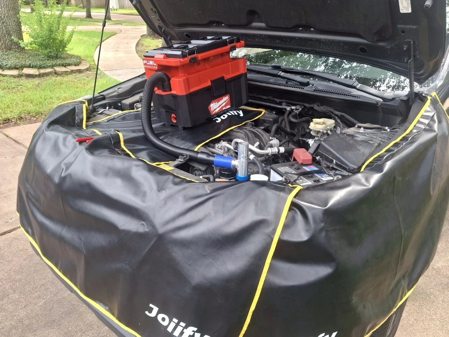 Engine bay and fender protection during mobile European car maintenance service in Missouri City, Texas