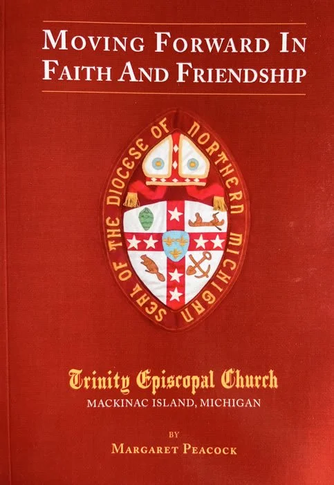 Cover of a book titled 'Moving Forward in Faith and Friendship' by Margaret Peacock. The background is red with a church emblem featuring a cross, various symbols, and the text 'The Diocese of Northern Michigan.' The book is about the Trinity Episcopal Church on Mackinac Island, Michigan.