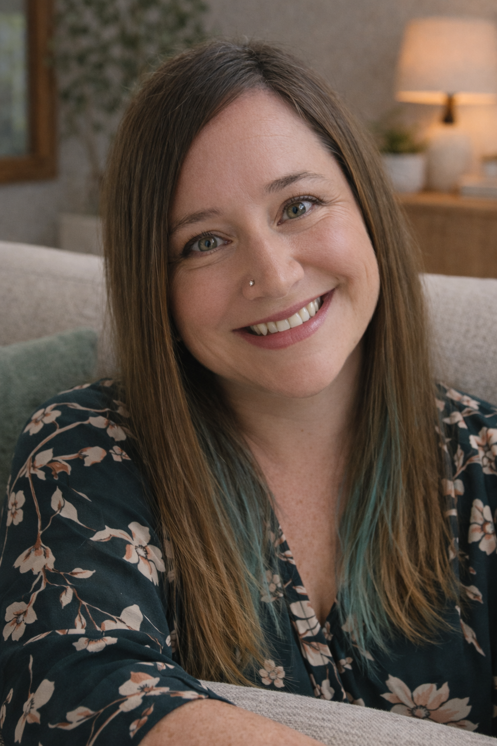 Sex Therapist Jess looks warmly at the camera, smiling, with her head tilted to the side.