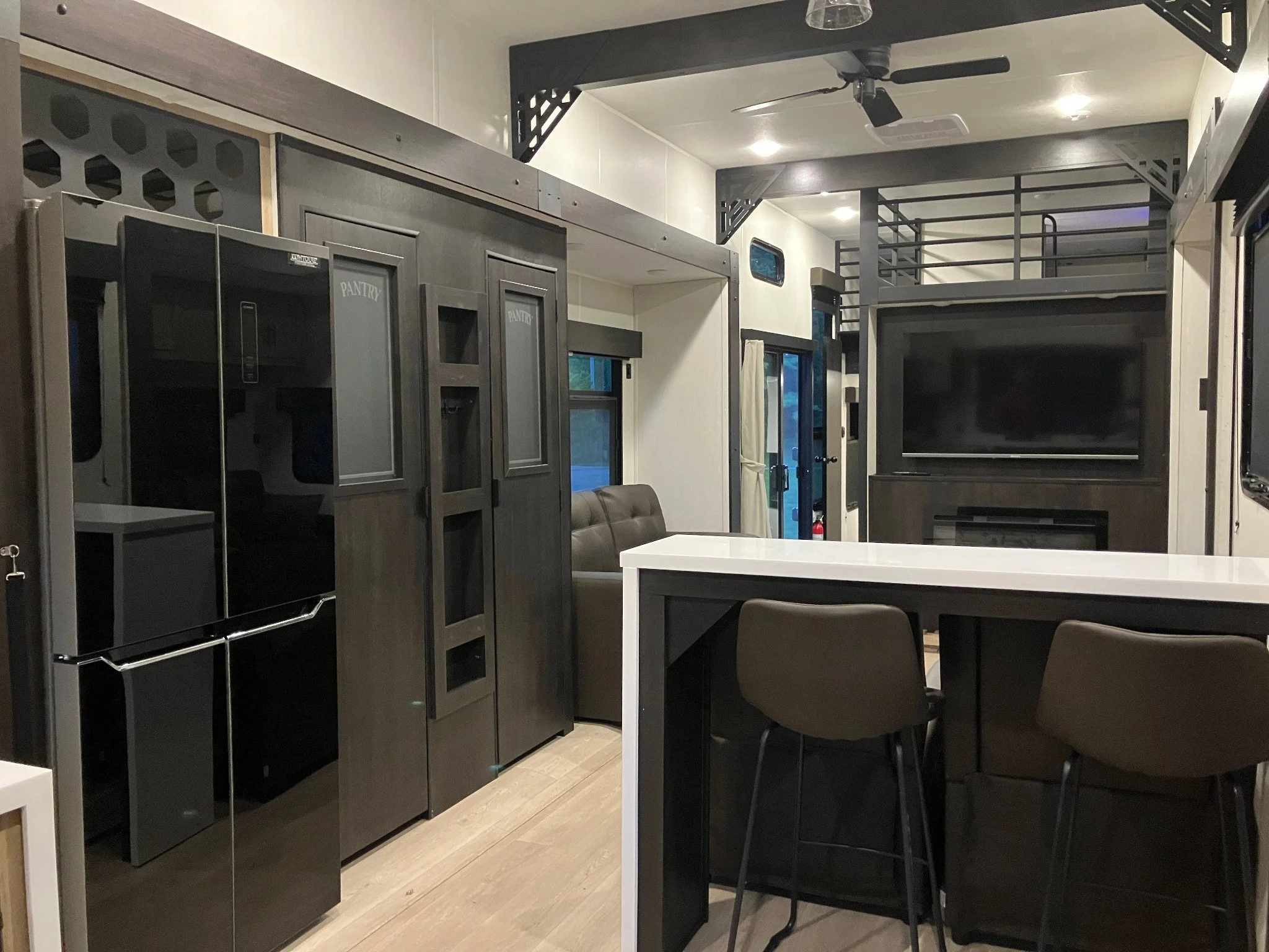 Open-concept kitchen, fireplace, television, and gathering space inside the Private Retreat Suite at Acres of Joy Ranch.