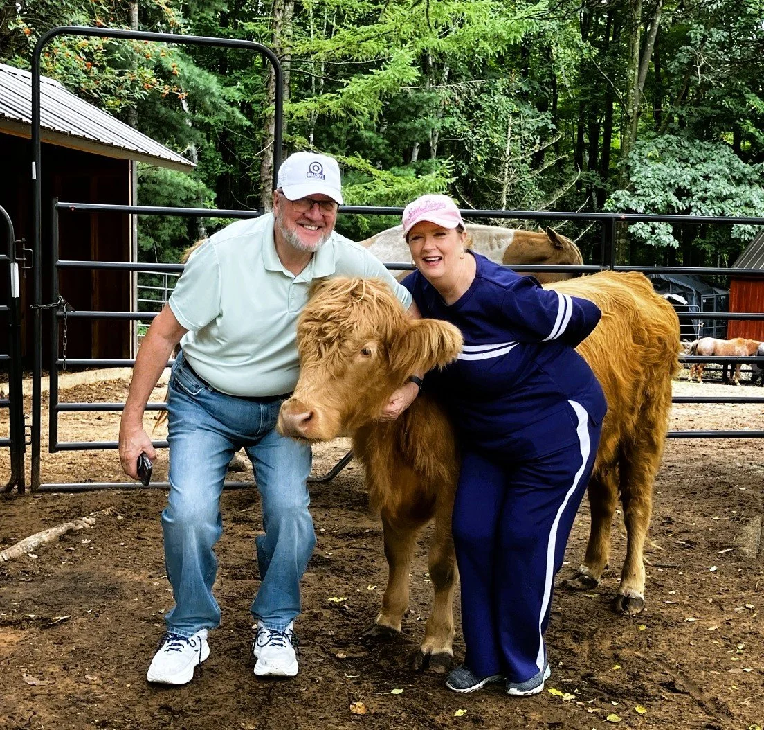Guests spending time with Ivy, a Highland cow, during a private animal experience at Acres of Joy Ranch in Sobieski, Wisconsin.