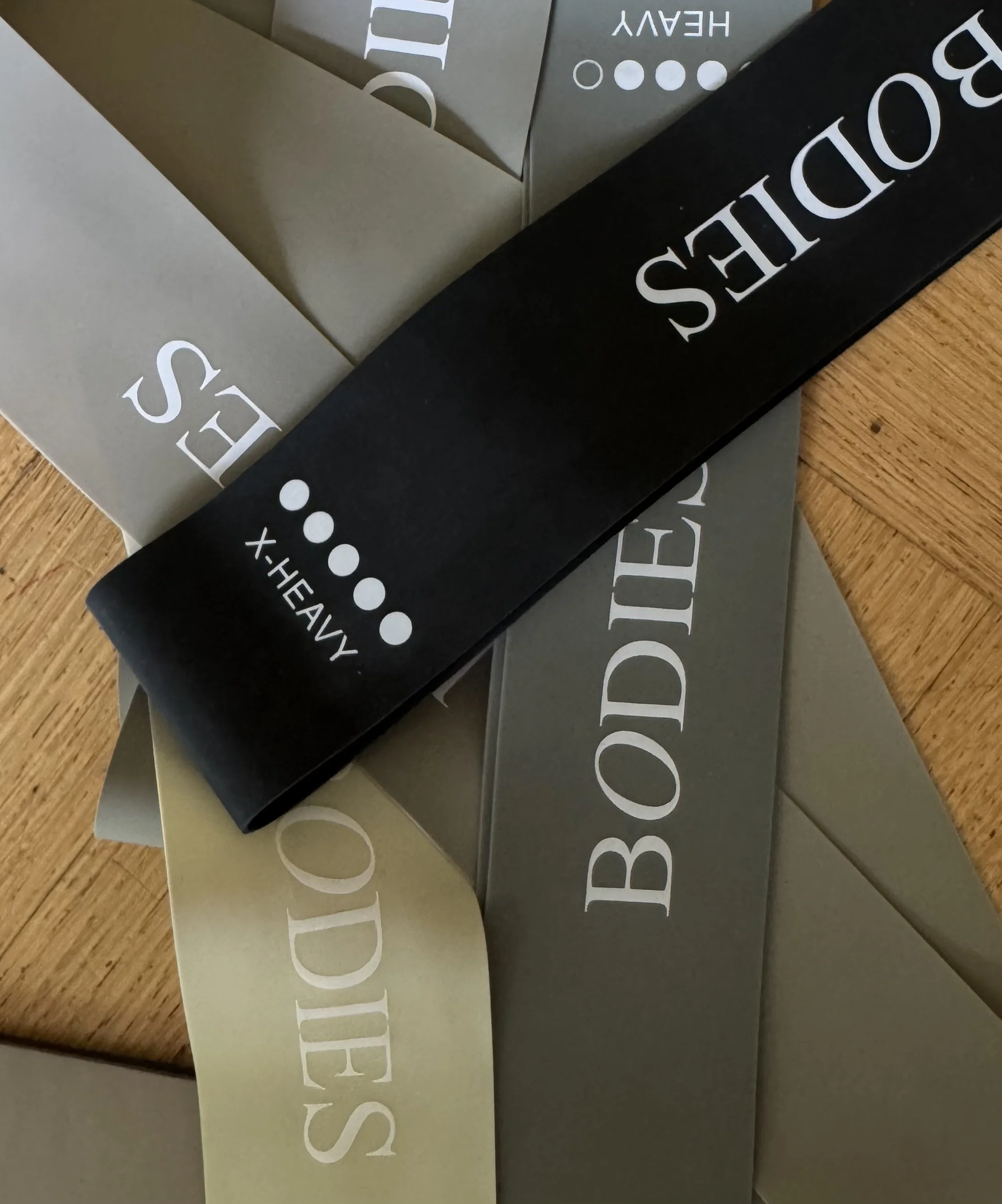 Close-up image of boxes with brand names on them, including 'CLOUDIES' and 'HEADY', arranged on a wooden surface.