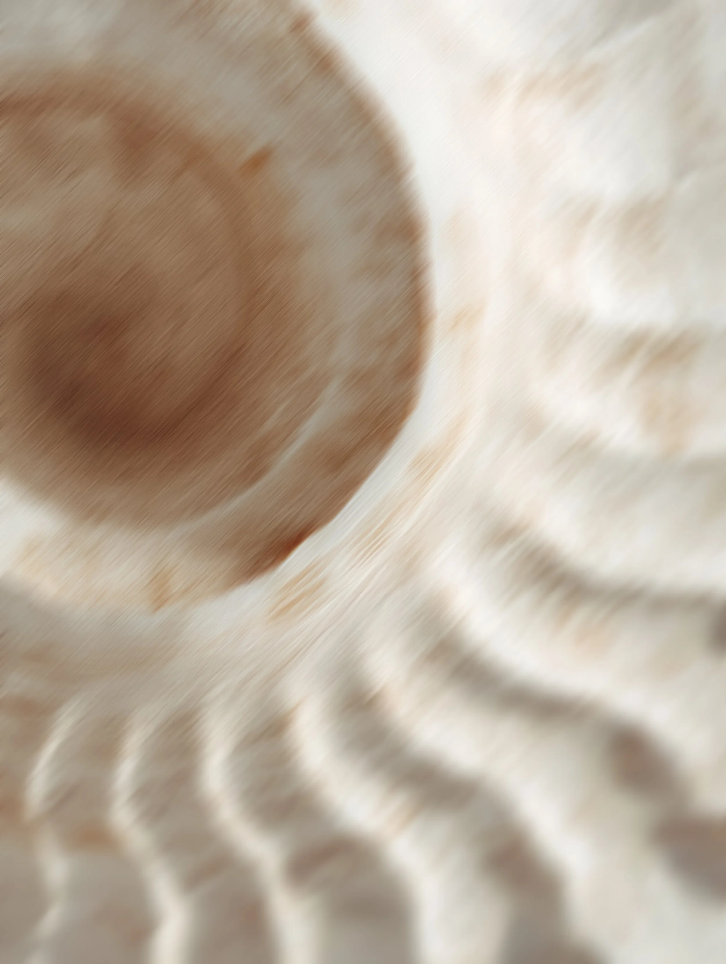 Close-up of a textured metal surface with a blurred, abstract background.