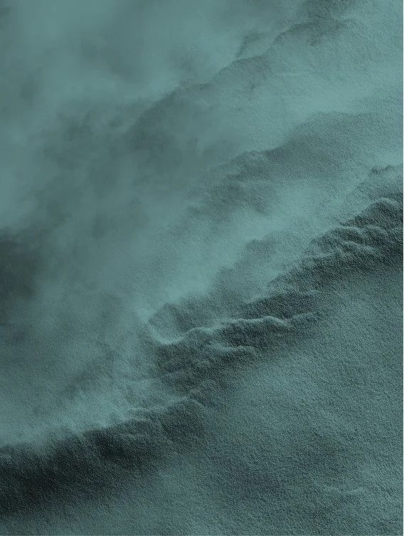 Close-up of greenish fabric or textured surface with soft folds and shadows.