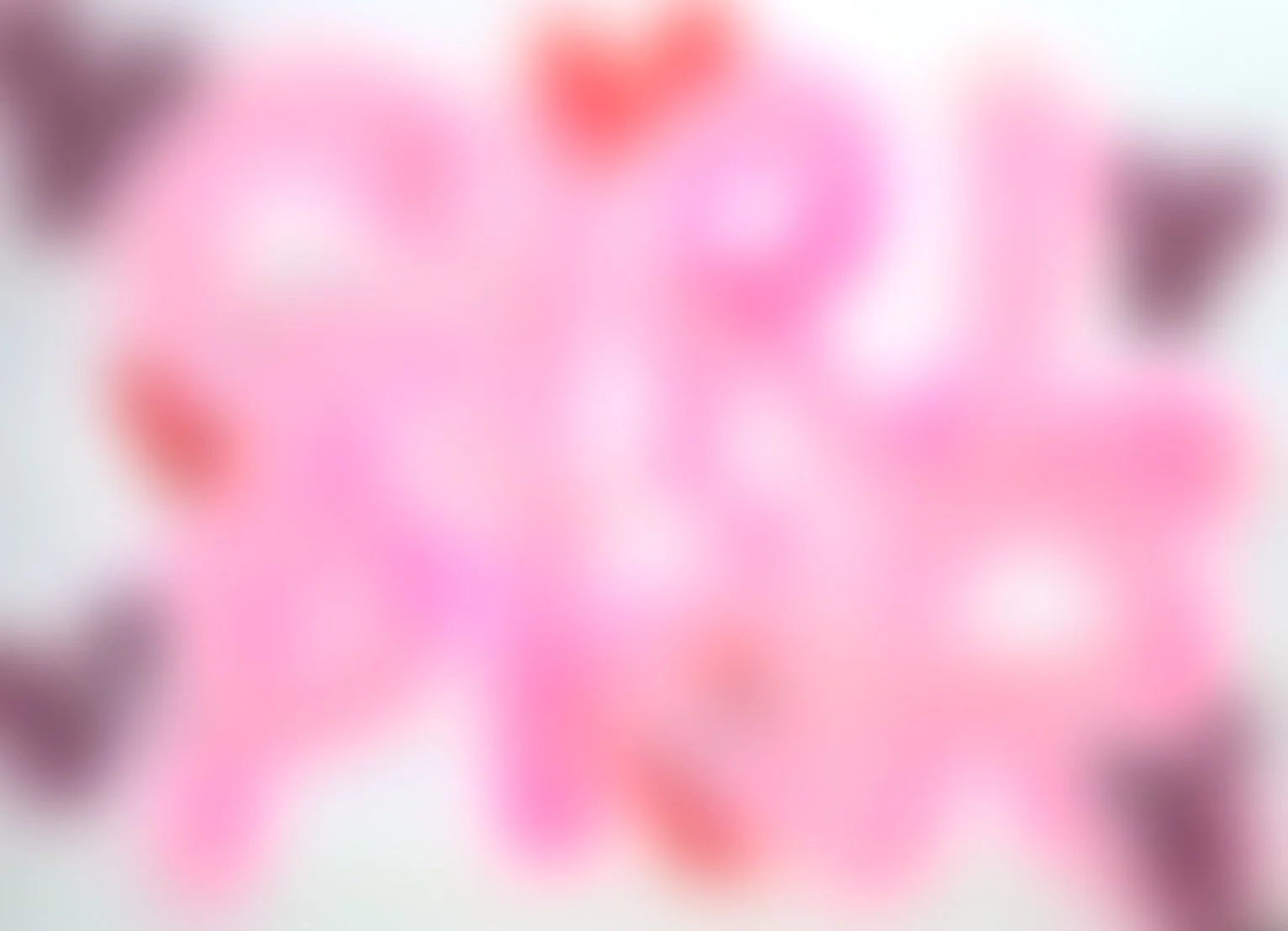Blurred image with various pink, red, and purple shapes and possibly flowers.