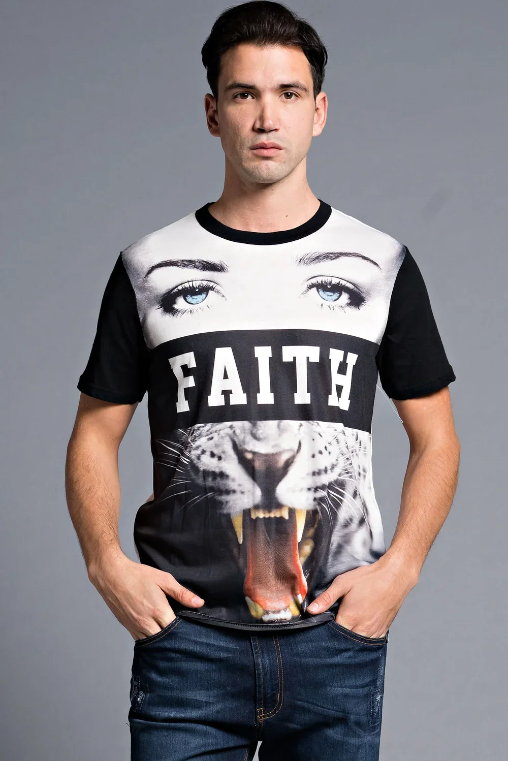 A young man with dark hair stands against a plain gray background, wearing a graphic t-shirt with a large image of a lion's open mouth and blue eyes, with the word 'FAITH' printed across the chest.