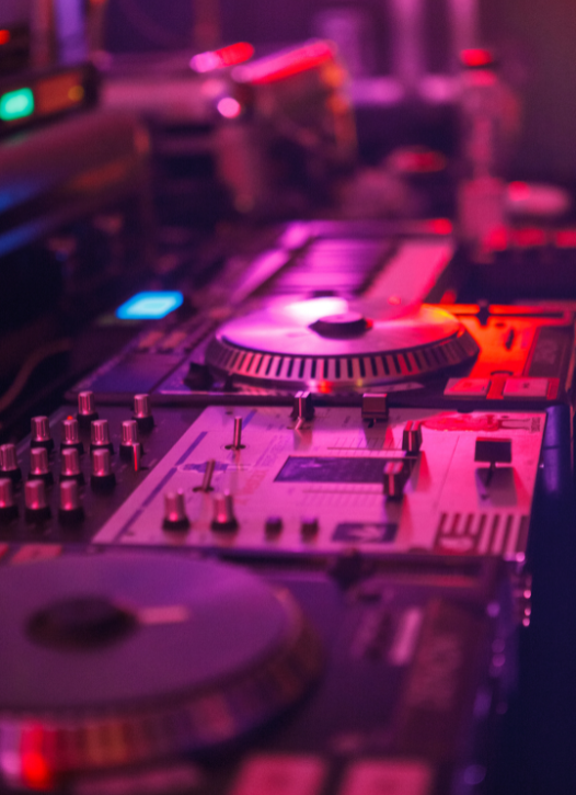 DJ mixing console with colorful LED lights.