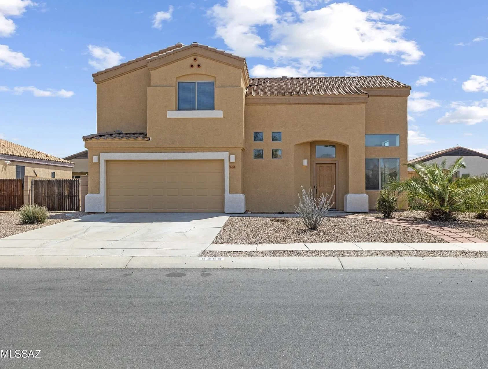 A stucco, two-story house that was sold in the 85747 zip code.