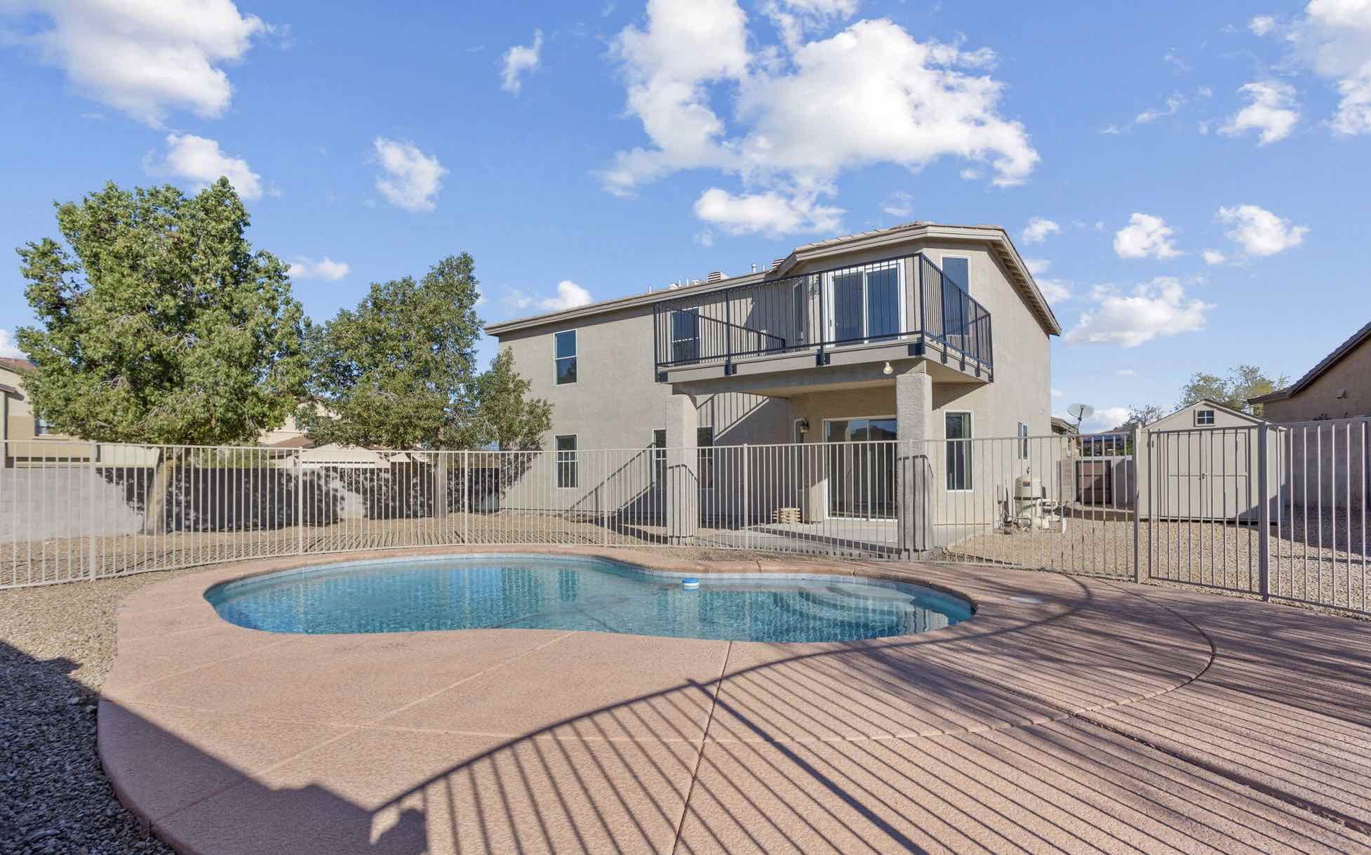 two story stucco home with pool