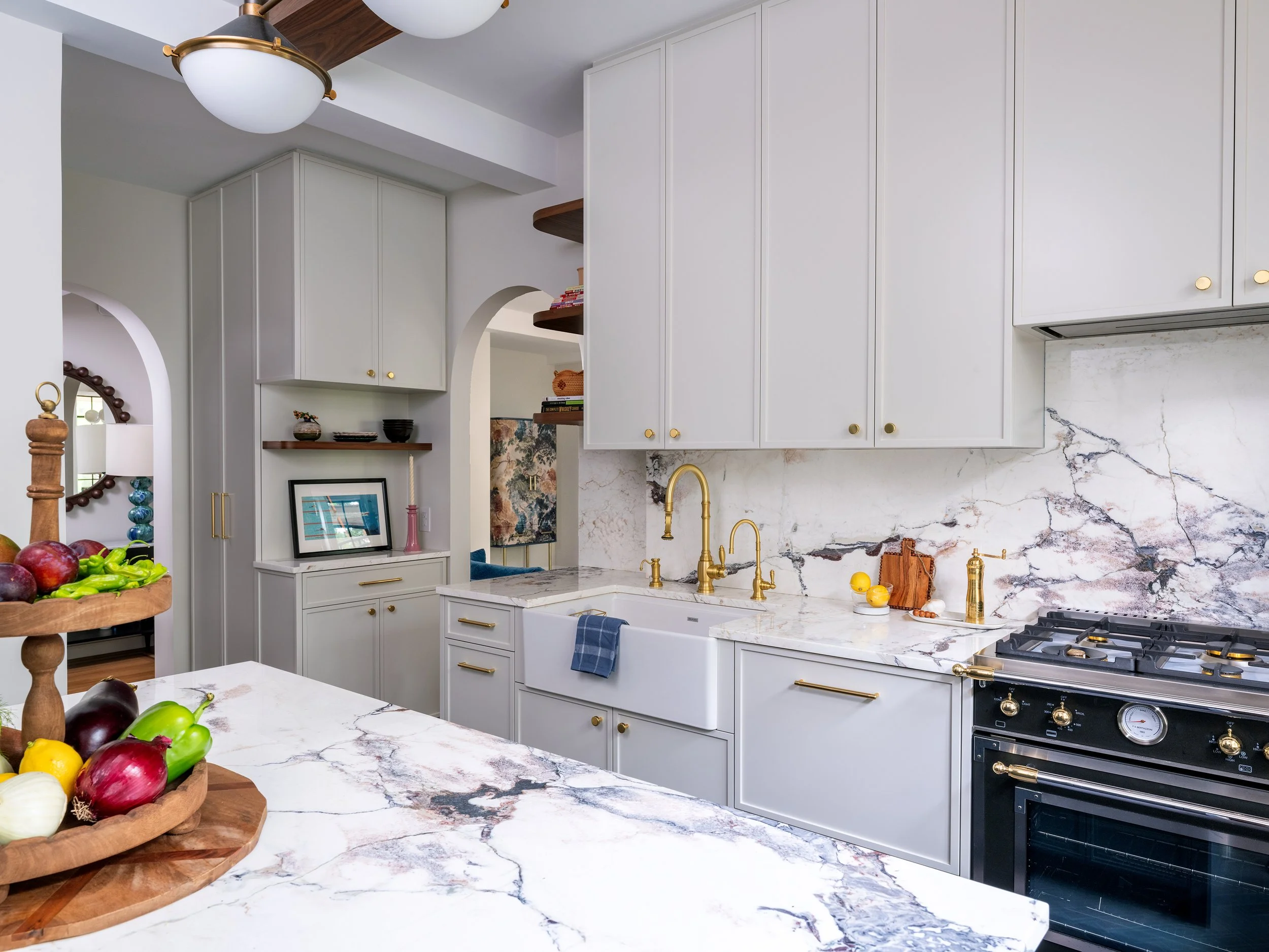 Forest Hills Apartment Renovation | Custom Kitchen with herrignbone flooring, marble counter tops and brass accents
